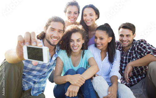 Smiling friends using media devices