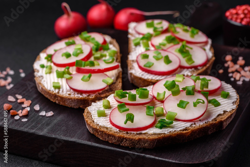 Delicious sandwich or bruschetta with cream cheese radish and green onions