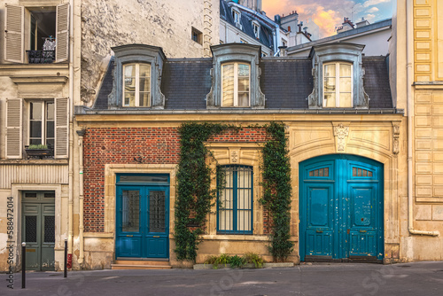 Authentic facade of historical building at sunset in Paris, France.