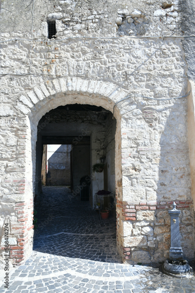 A narrow street among the old houses of Torre Cajetani, a medieval town in the province of Frosinone in Italy. A narrow street among the old houses of Torre Cajetani, a medieval town in the province of Frosinone in Italy.