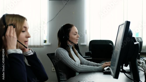Woman wearing headset works in office to support remote client. Call center, telemarketing, customer support agent. diverse group of people is negotiating hotline. hotline employee talks to customers