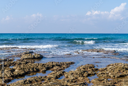 Sea low tide on the Mediterranean coast, exposing brown rocks