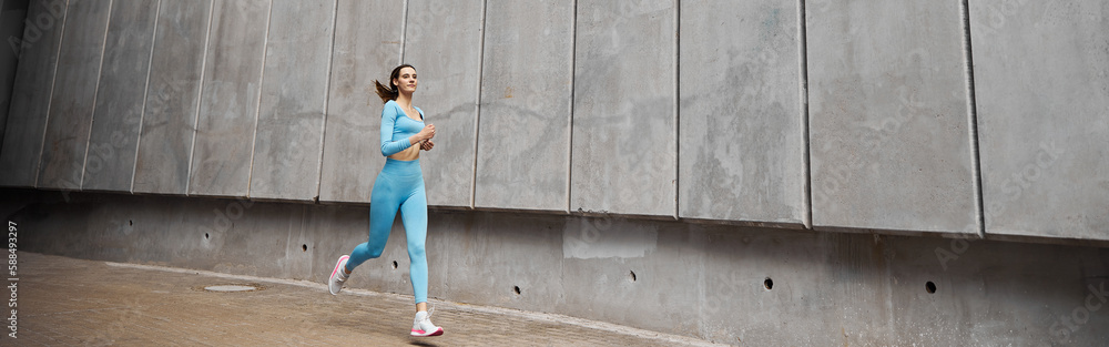 Beautiful fit young woman jogger is running outdoors Beautiful fit young woman jogger is running outdoors