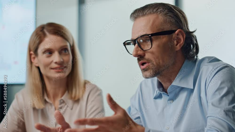 Professional man talking colleagues office. Business couple presenting project Professional man talking colleagues office. Business couple presenting project