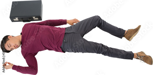 High angle view of businessman sleeping by briefcase