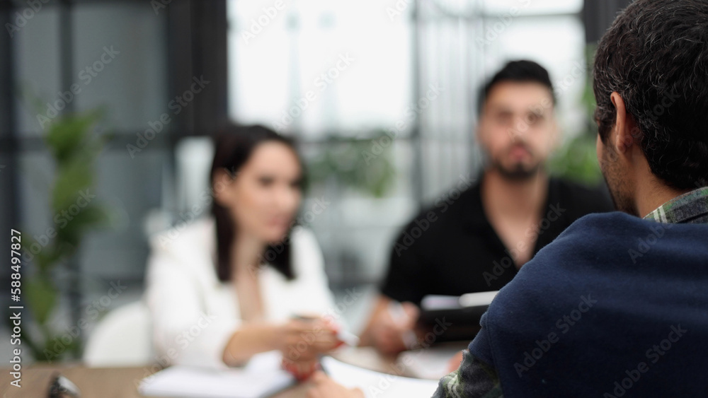 Fototapeta premium business people sitting at the table talking back view