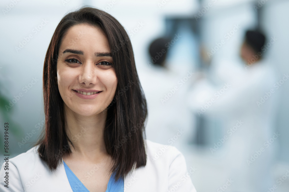 Image of confident female doctor, intern with medical robe, looking confident at camera Image of confident female doctor, intern with medical robe, looking confident at camera