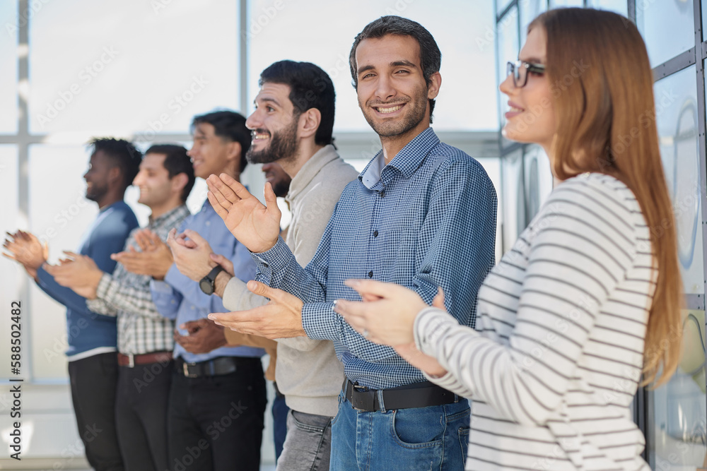 Happy business team applauding after successful meeting Happy business team applauding after successful meeting