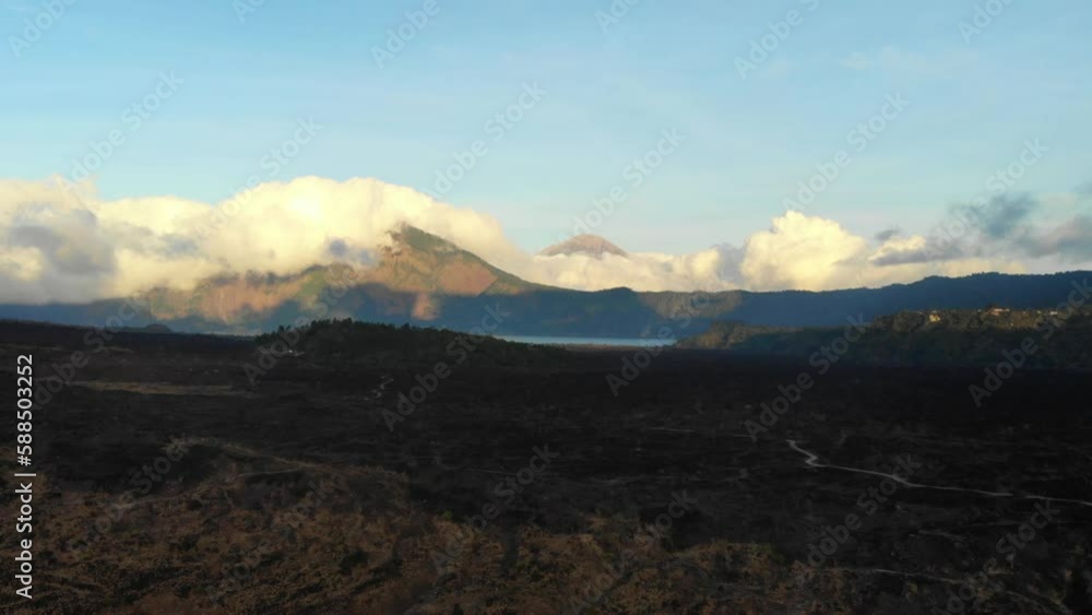 drone fly over lava vield in front of Gunung Batur with view over Gunung Agung in Bali drone fly over lava vield in front of Gunung Batur with view over Gunung Agung in Bali