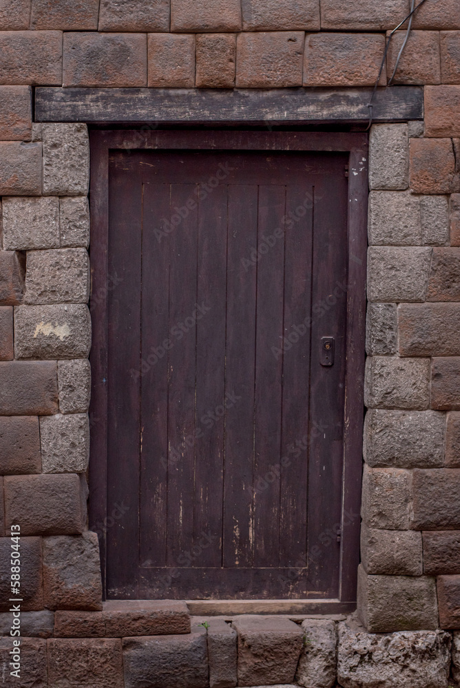 old wooden door with stone wall in Cuzco Peru old wooden door with stone wall in Cuzco Peru