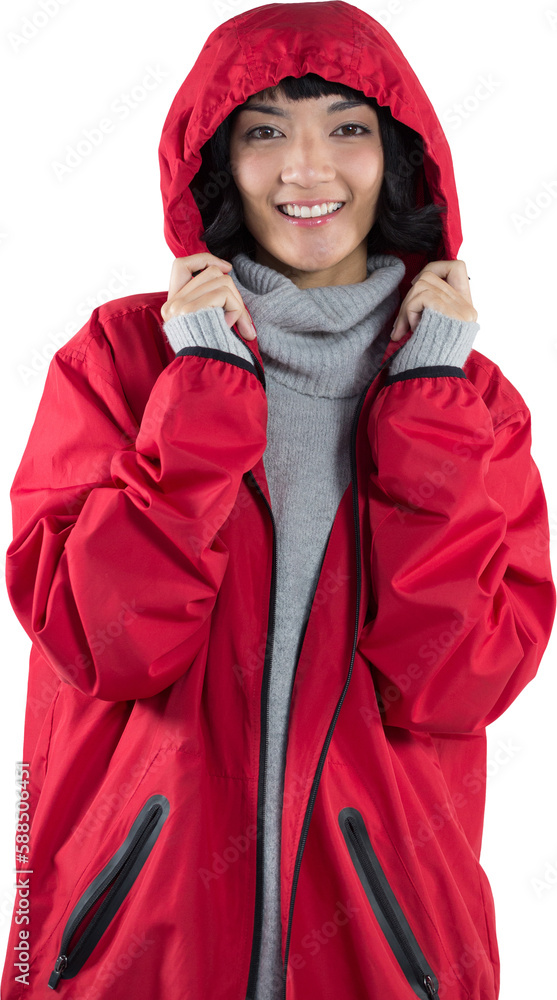 Smiling woman in hooded jacket standing against white background Smiling woman in hooded jacket standing against white background