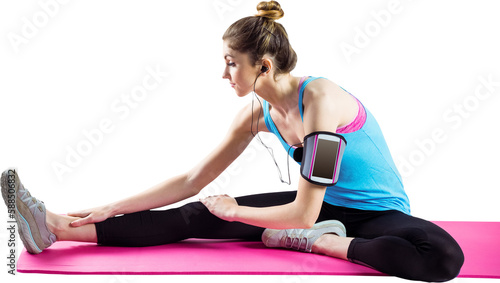 Young woman stretching on exercise mat