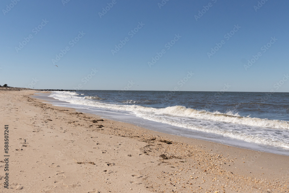 I loved the look of this beach as the waves battered the shore. The whitecaps of the waves make it look rough. The beautiful blue sky with no clouds in site make this look like a beautiful summer day.