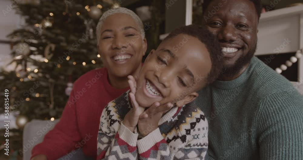 Family Looking at Camera on a Video call with Grandparents at Christmas time Family Looking at Camera on a Video call with Grandparents at Christmas time