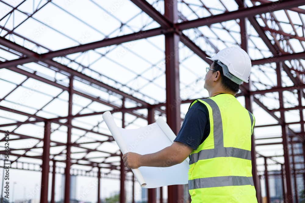 Professional engineer architect worker with protective helmet and blueprints paper at house building construction site Professional engineer architect worker with protective helmet and blueprints paper at house building construction site