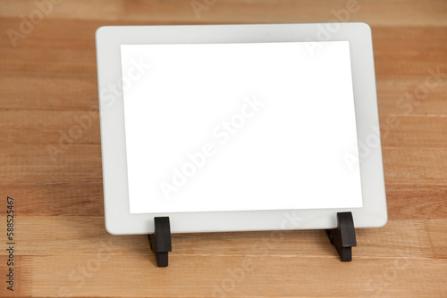 Digital tablet on wooden plank