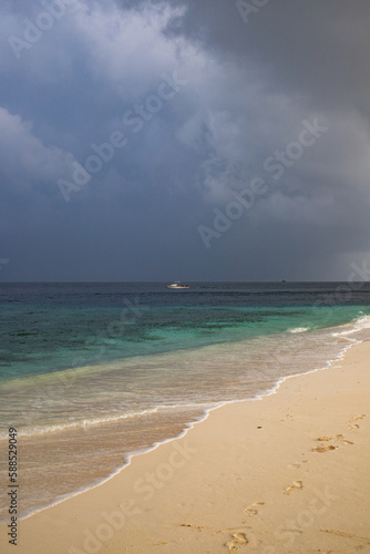 beautiful exotic tropical beach and stormy clouds