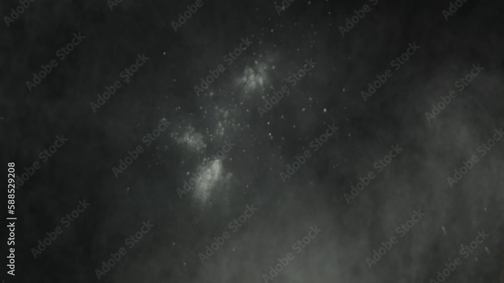 Throwing flour on a black background. White dust explosion effect. For different effects. Flour is falling everywhere. White dust on a black background Throwing flour on a black background. White dust explosion effect. For different effects. Flour is falling everywhere. White dust on a black background