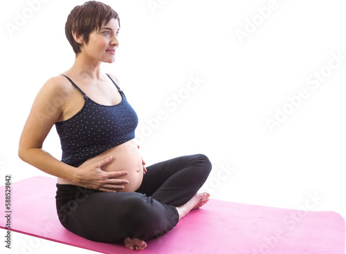 Full length of pregnent woman sitting on exercise mat