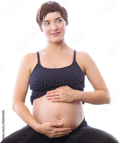 Thoughtful pregnant woman holding belly
