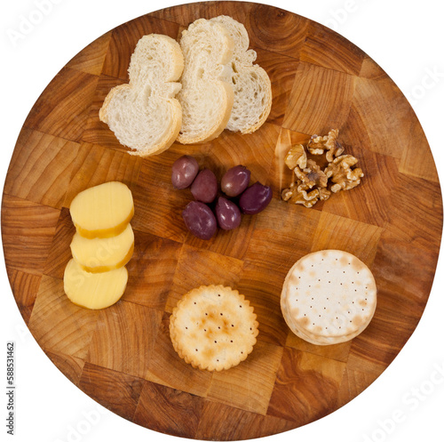 Cheese, bread, olives, biscuits and walnut on wooden board