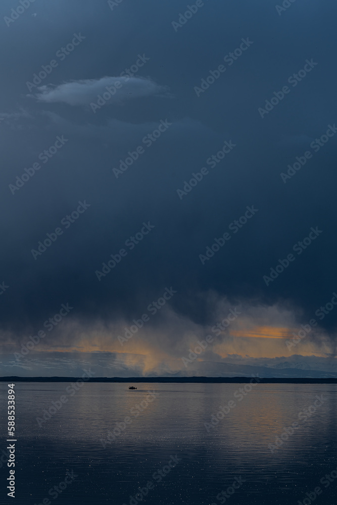 Rain Cloud and Fishing Boat on Potholes Reservoir close to Moses Lake, WA Rain Cloud and Fishing Boat on Potholes Reservoir close to Moses Lake, WA