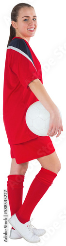Cute football player standing with ball