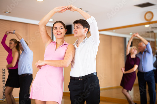 girl with young man are studying samba dance at ballroom dancing lesson