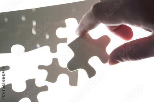Cropped hand of man holding puzzle piece