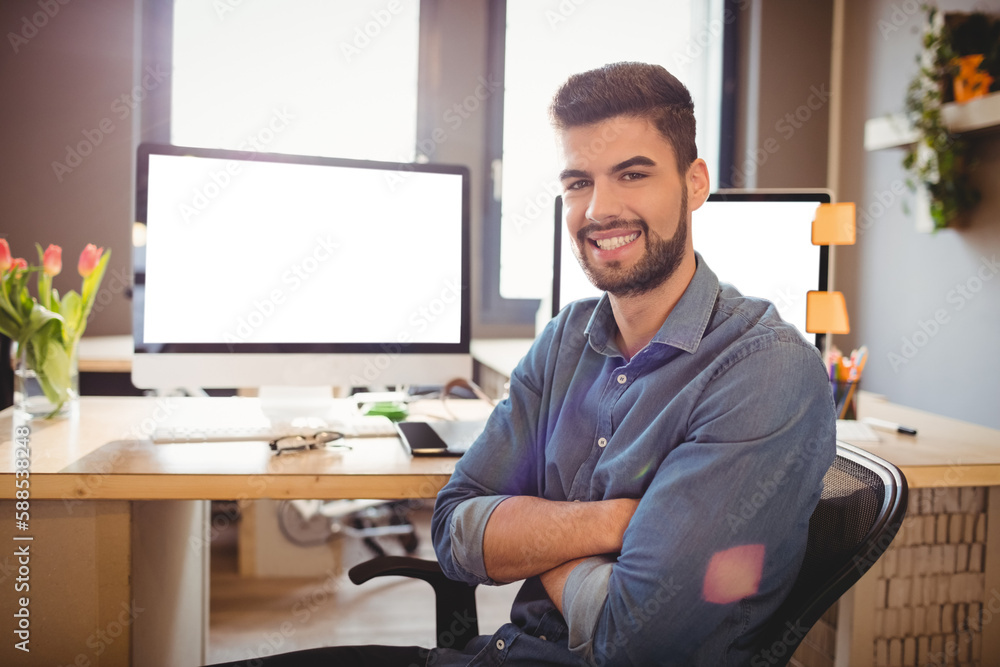 Portrait of happy graphic designer sitting at office Portrait of happy graphic designer sitting at office