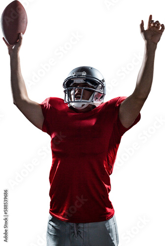 American football player cheering while holding ball