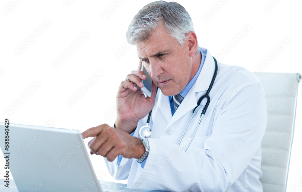 Male doctor pointing at laptop while using mobile phone Male doctor pointing at laptop while using mobile phone