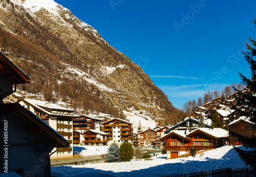 Cityscape view of Zermatt city with snow on the roofs in a sunny day of winter season, Switzerland © JackF