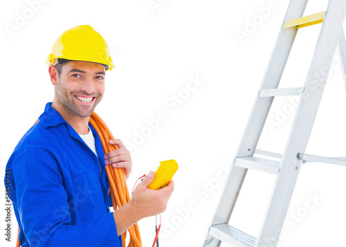 Smiling male electrician holding multimeter in office photo