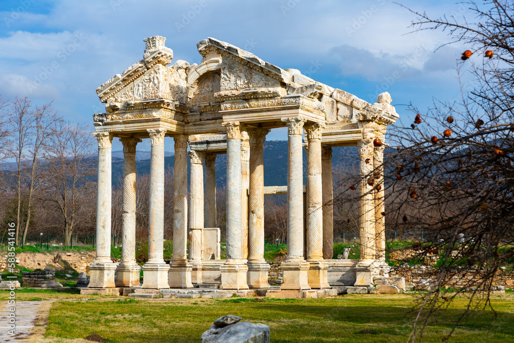 Fototapeta premium Ancient ruined construction of monumental gate of small Greek city of Aphrodisias in classical architectural form of tetrapylon located in modern Aydin Province, Turkey