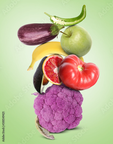 Fototapeta Naklejka Na Ścianę i Meble -  Stack of different vegetables and fruits on pale light green background
