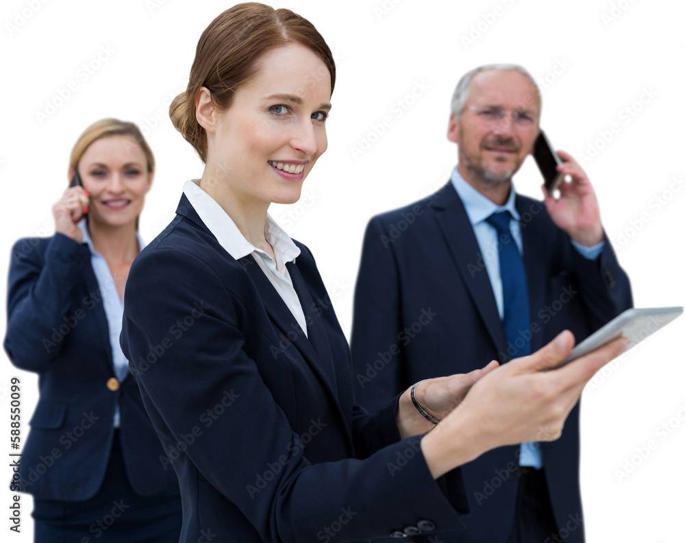 Businesswoman using tablet while colleagues talking on phone in background Businesswoman using tablet while colleagues talking on phone in background