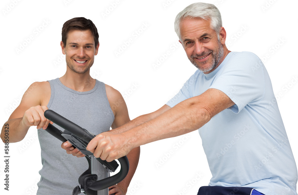 Happy mature man on stationary bike with trainer Happy mature man on stationary bike with trainer