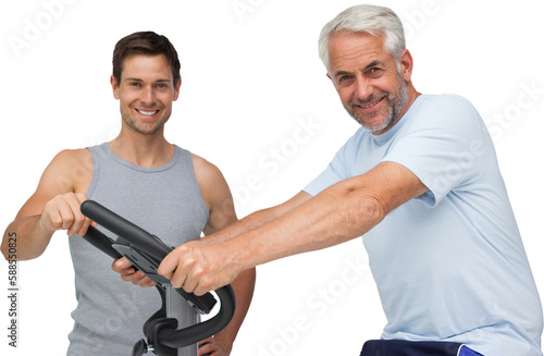 Happy mature man on stationary bike with trainer
