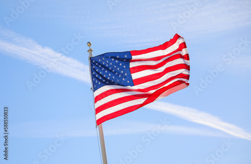 The US flag on a pole is a symbol of patriotism and unity, representing the country's values, history, and people. Its design and colors have symbolic meaning