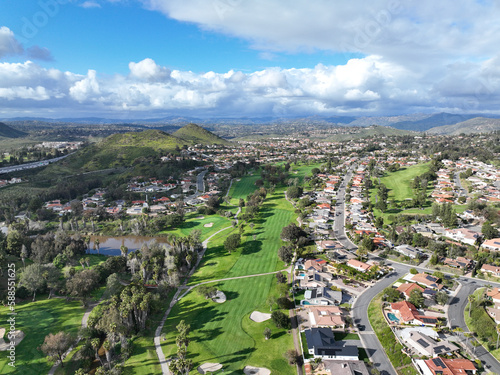 Aerial view of residential neighborhood surrounded by golf and valley during cloudy day in Rancho Bernardo, San Diego County, California. USA. 