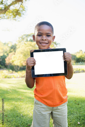 Young boy holding digital tablet