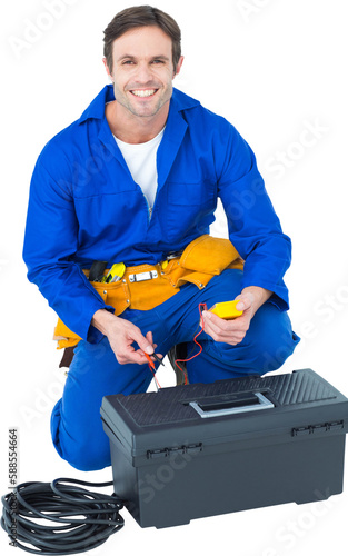 Happy electrician holding multimeter photo