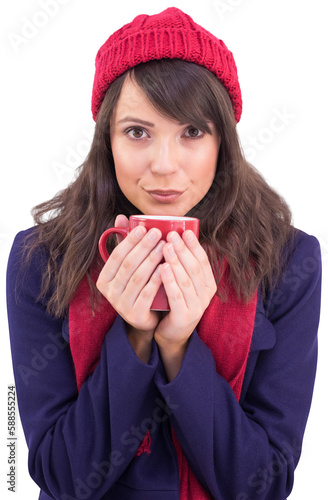 Festive brunette holding a mug