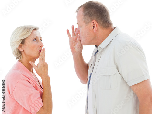 Older couple holding hands to mouth for silence
