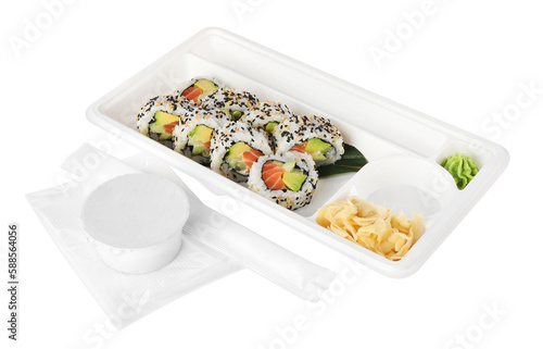 Food delivery. Plastic container with delicious sushi rolls near bowl of soy sauce and chopsticks on white background