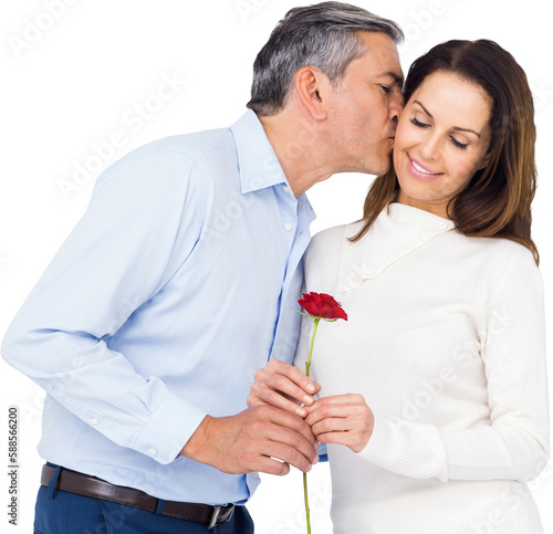 Husband kissing wife while holding rose