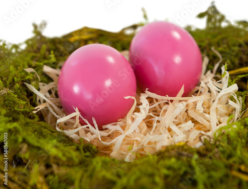 Pink Easter eggs on paper nest