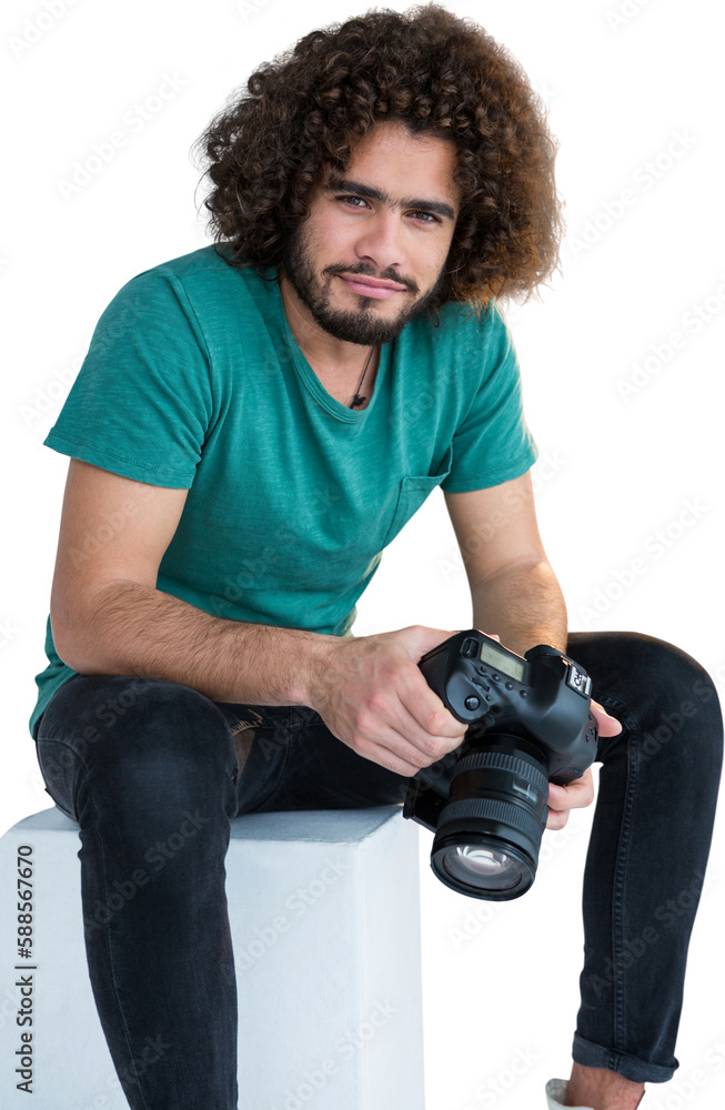 Portrait of male photographer holding camera while sitting on seat Portrait of male photographer holding camera while sitting on seat
