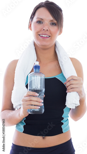 Portrait of woman in sportswear holding towel around neck and wa